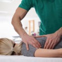 chiropractor adjusting a woman’s back