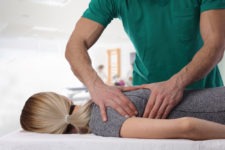 chiropractor adjusting a woman’s back